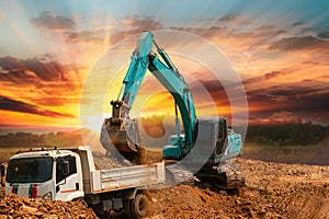 Crawler Excavator digging the soil into a truck ,In the construction site