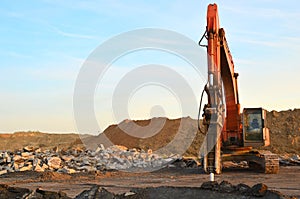 Crawler excavator with hydraulic hammer for the destruction of concrete and hard rock at the construction site.