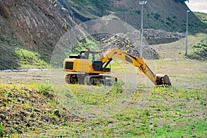 a crawler excavator operates in mountainous terrain.