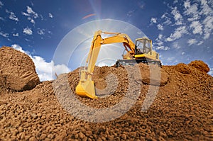 Crawler excavators are digging soil at construction site .