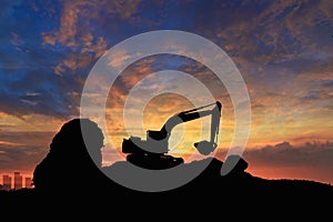 Crawler excavators silhouette are digging the soil in the construction site.