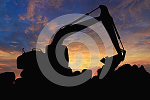 Crawler excavators silhouette are digging the soil in the construction site.