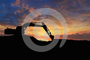 Crawler excavators silhouette are digging the soil in the construction site