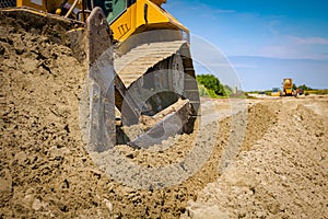 Crawler tracks, bulldozer machine is leveling construction site
