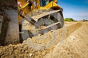 Crawler tracks, bulldozer machine is leveling construction site