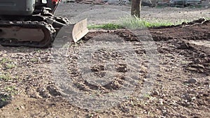 Crawler tracks of moving excavator in operation on a dirt site