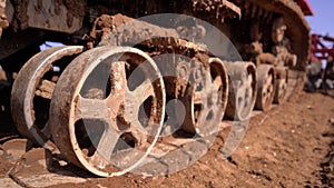 Crawler tracks of a plowing tractor and a field in early spring, a plowed field for crops, close-up,