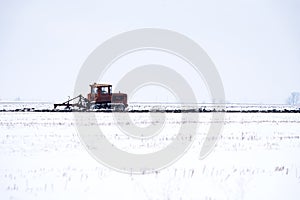 Crawler Tractor plowing field.