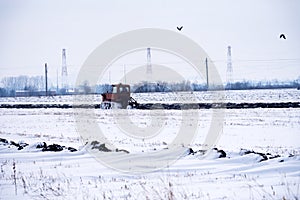 Crawler Tractor plowing field.