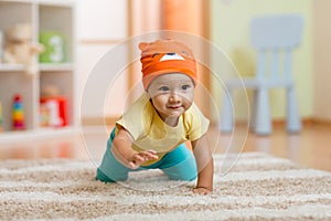 Crawling baby boy at home on floor