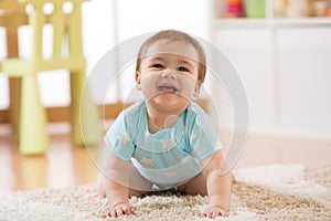 Crawling baby boy at home on floor