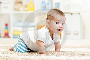 Crawling baby boy indoors photo