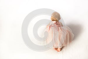 A Crawling Baby Girl in Pink Frilly Party Dress photo