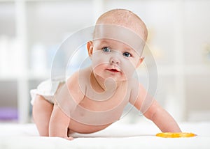 Crawling baby weared in diaper