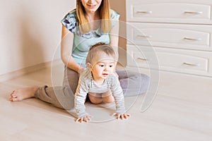 Crawling funny baby boy indoors at home