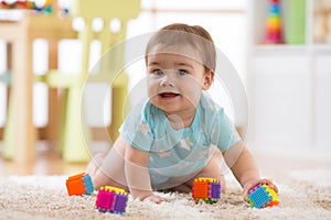 Crawling funny baby boy indoors at home