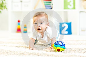 Crawling funny baby boy at nursery