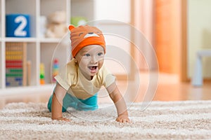 Crawling kid or child at home on carpet