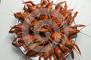 Crayfish on a plate with lemon on the white background