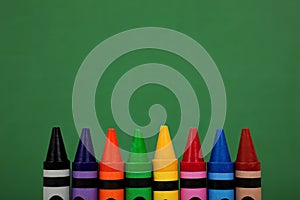 Crayon tops with a green chalkboard background