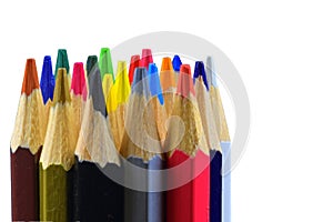 Crayons and pastels lined up. Close up of an assortment colored pencils tips on white background. Background of colorful