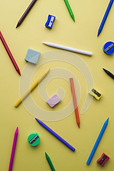 Crayons, pencil sharpeners and erasers of different colors