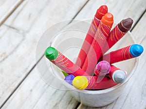 Crayons in plastic glass