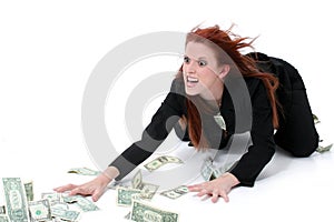 Crazed Business Woman Grabbing Money From Floor photo