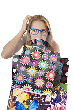 Crazy amusing confused girl with shopping gift bags.