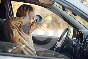 Crazy Angry Man Annoyed While Driving a Car. Mad Agrressive Driver Screaming Irritated with Traffic