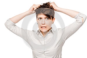 Crazy angry woman tearing her hair on a white