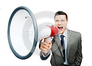 Crazy Asian businessman screaming in megaphone on white background