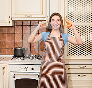 Crazy baking cooking woman having fun in her kitchen smiling che