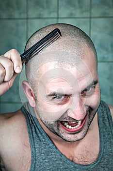 Crazy bald man with black comb