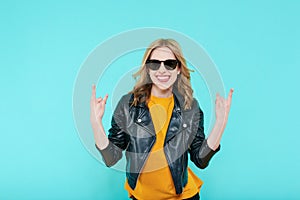 Crazy beautiful rock Girl in leather jacket and black sunglasses. Punk is not dead. Attractive cool young woman.