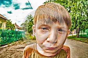 Crazy boy looking into the camera on the street close-up wide-angle plan, XDR photo