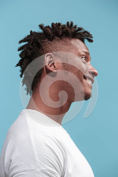 The crazy business Afro-American man standing and wrinkle face blue background. Profile view.