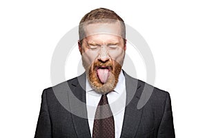 Crazy businessman with clossed eyes and tongue.