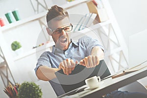 Crazy businessman tearing organizer apart