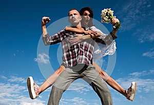 Crazy couple having fun outdoor. Young fun excited couple piggyback ride in summer day. Happy young couple having fun on
