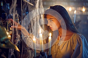 Crazy demonic woman with candle choosing potions