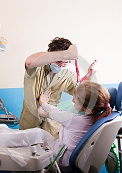 Crazy dentist treats teeth of the unfortunate patient. The patient is terrified.