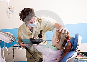 Crazy dentist treats teeth of the unfortunate patient. The patient is terrified.