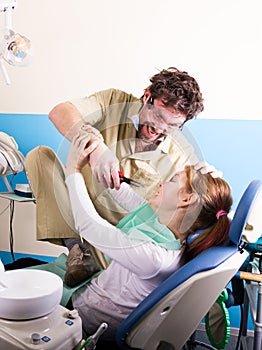 Crazy dentist treats teeth of the unfortunate patient. The patient is terrified.