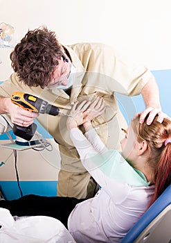 Crazy dentist treats teeth of the unfortunate patient. The patient is terrified.