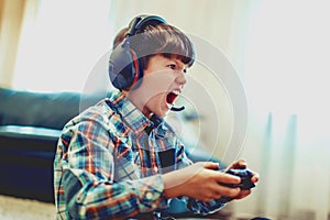 Crazy dependent kid shouting while playing mass multiplayer video game online