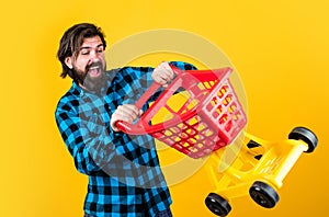 Crazy driver. handsome hipster wear checkered shirt in shop. mature shopper go shopping in mall. bearded man carry