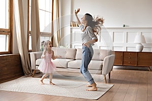 Crazy energetic family of two dancing in living room.