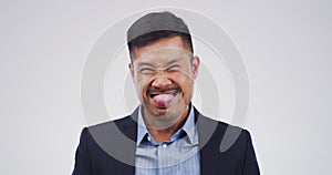 Crazy expression, face of businessman in studio with funny and positive attitude for meme, post or comedy. Goofy emoji