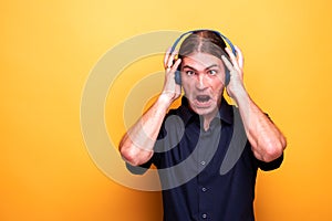 Crazy face of crosseyed man wearing headphones